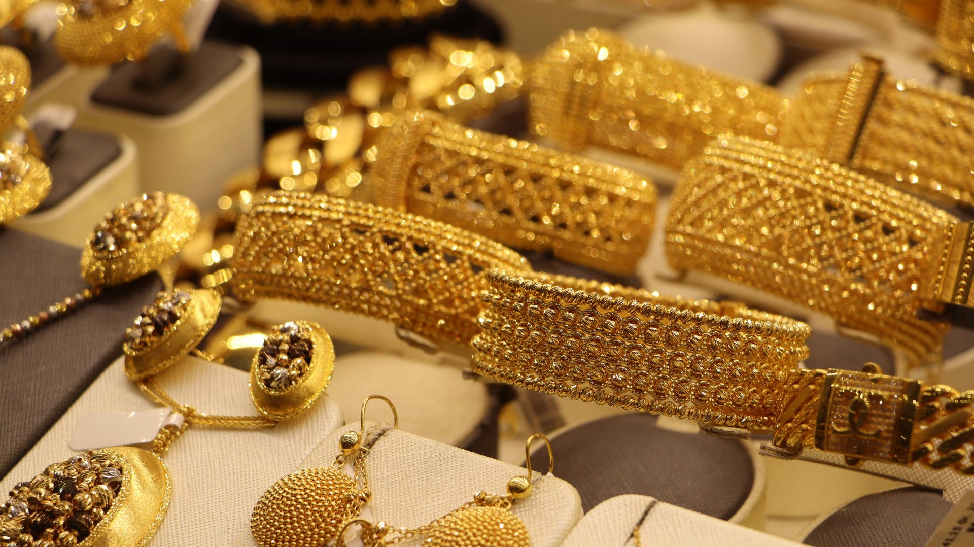 a bunch of gold jewelry on display in a store